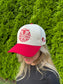 Woman wearing The Stampede Snapback hat with head tilted down, showing front embroidery.