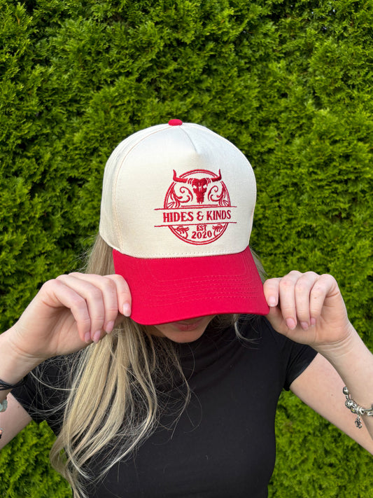Close-up of woman adjusting The Stampede Snapback hat with both hands.