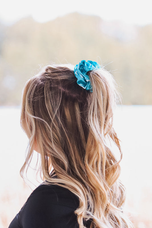 Woman wearing teal cactus scrunchie in ponytail – western hair accessory