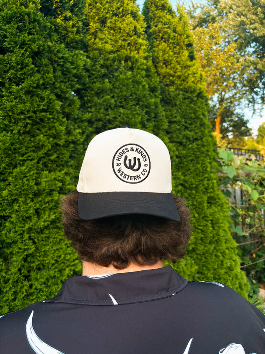 Back view of The Outrider Hat by Hides & Kinds, showing embroidered circular HK logo.