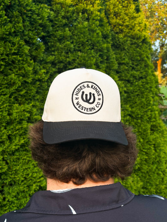 Back view of The Outrider Hat by Hides & Kinds, showing embroidered circular HK logo.