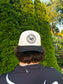 Back view of The Outrider Hat by Hides & Kinds, showing embroidered circular HK logo.