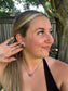 Triple Stone Stud earrings in black onyx under natural light