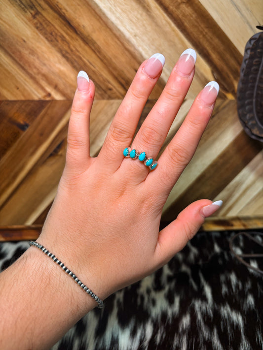 Close-up of turquoise teardrop cluster ring in sterling silver