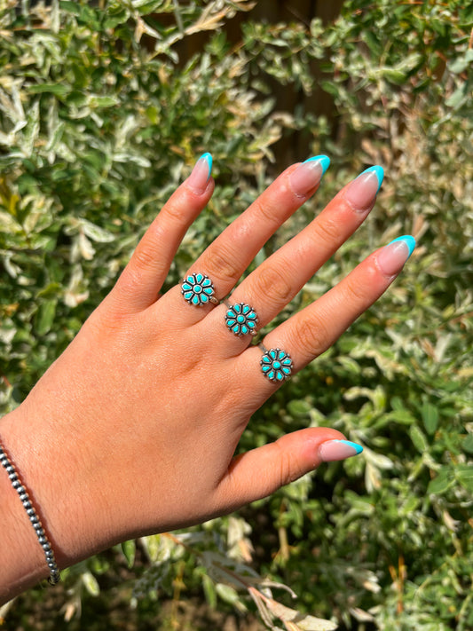 Hand wearing turquoise flower ring with sterling silver band – western jewelry by Hides & Kinds
