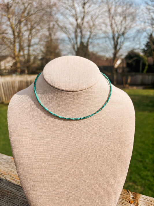 Minimal single strand look of the Turquoise Sierra Necklace on beige jewelry bust.