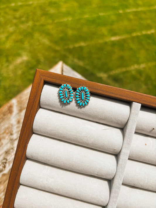 Handmade turquoise cluster stud earrings on display