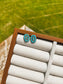 Handmade turquoise cluster stud earrings on display