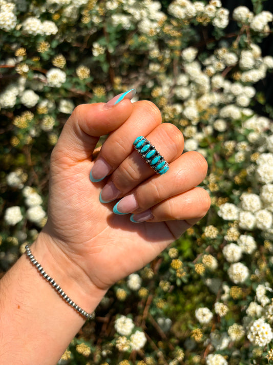 Close-up of turquoise marquise ring with oval stones in sterling silver setting